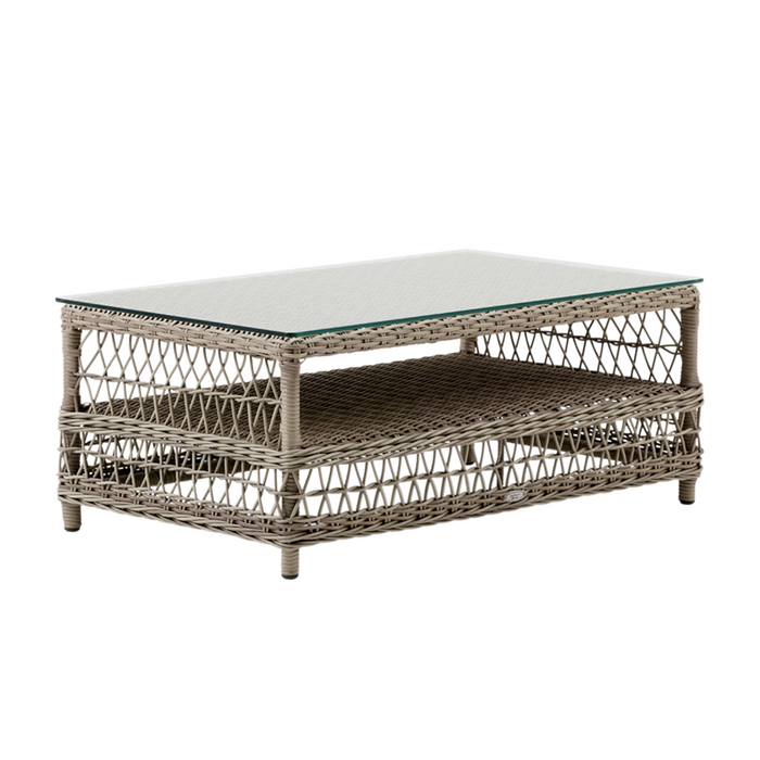 Gray wicker coffee table with a glass top, featuring intricate woven patterns and an open shelf design.