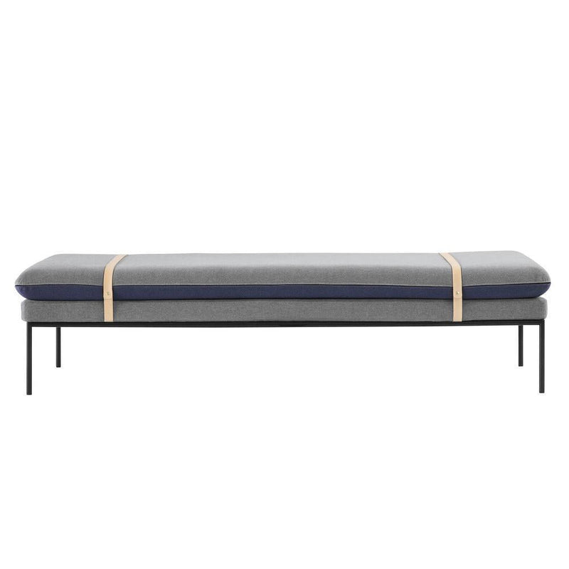 Gray and navy patterned cushion on a sleek black metal frame, enhanced with stylish beige straps.