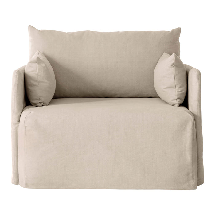 Beige sofa with textured fabric and matching plump pillows, perfect for a cozy living space.