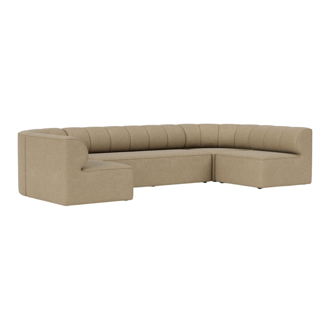 Beige curved sectional sofa with soft tufted detailing, featuring a minimalist design and smooth fabric texture.