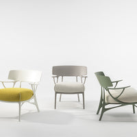 Three stylish chairs: vibrant yellow, soft white, muted gray, and earthy green, featuring smooth and textured fabrics.