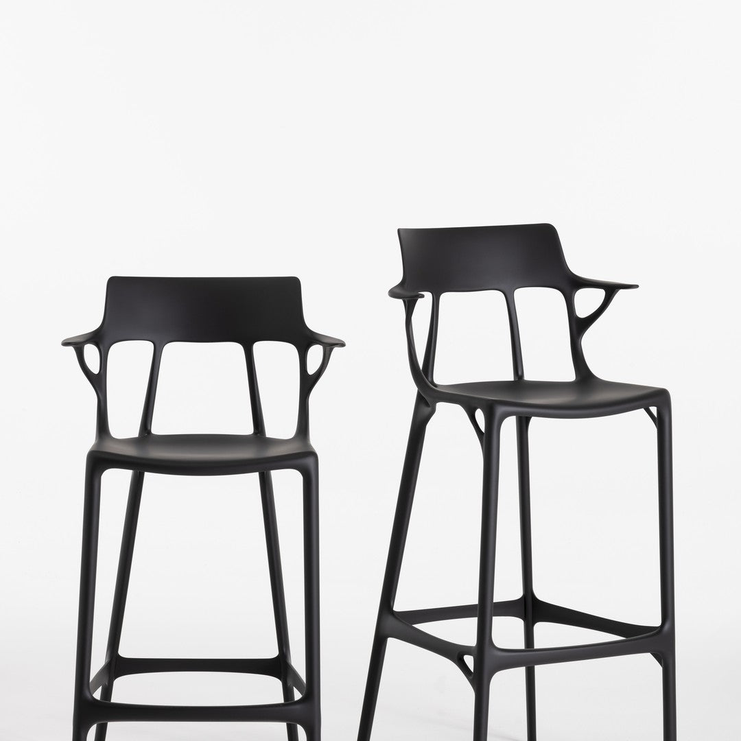 Set of two sleek black bar stools with unique cut-out patterns, perfect for modern decor.