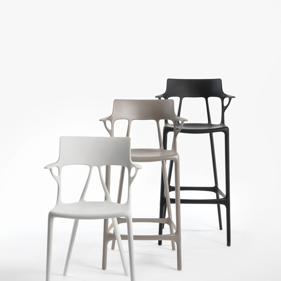 Three modern bar stools in white, taupe, and black, showcasing sleek designs with open back patterns.