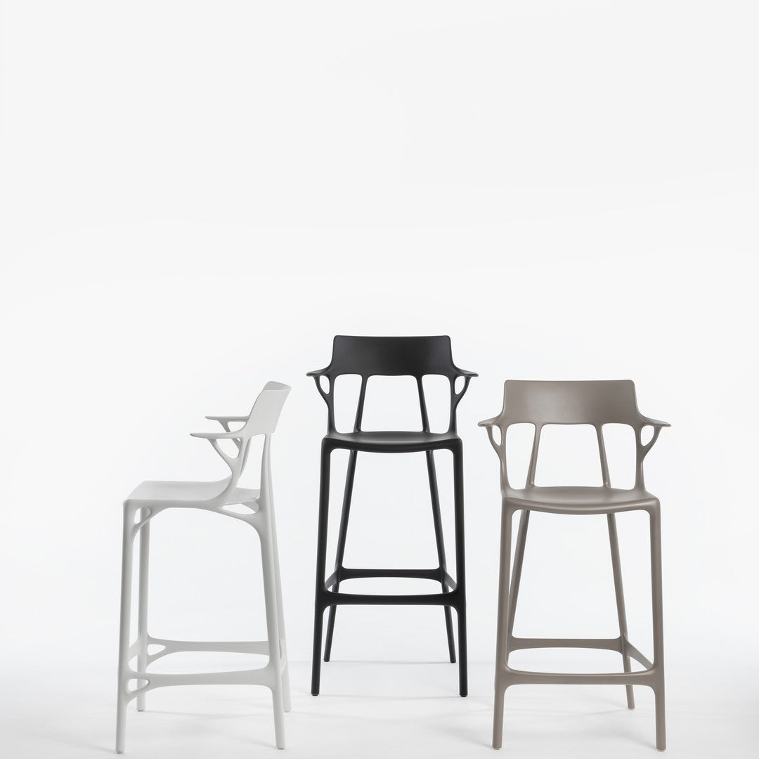 Stylish bar stools in matte white, black, and taupe with modern, sleek designs and unique cutout patterns.
