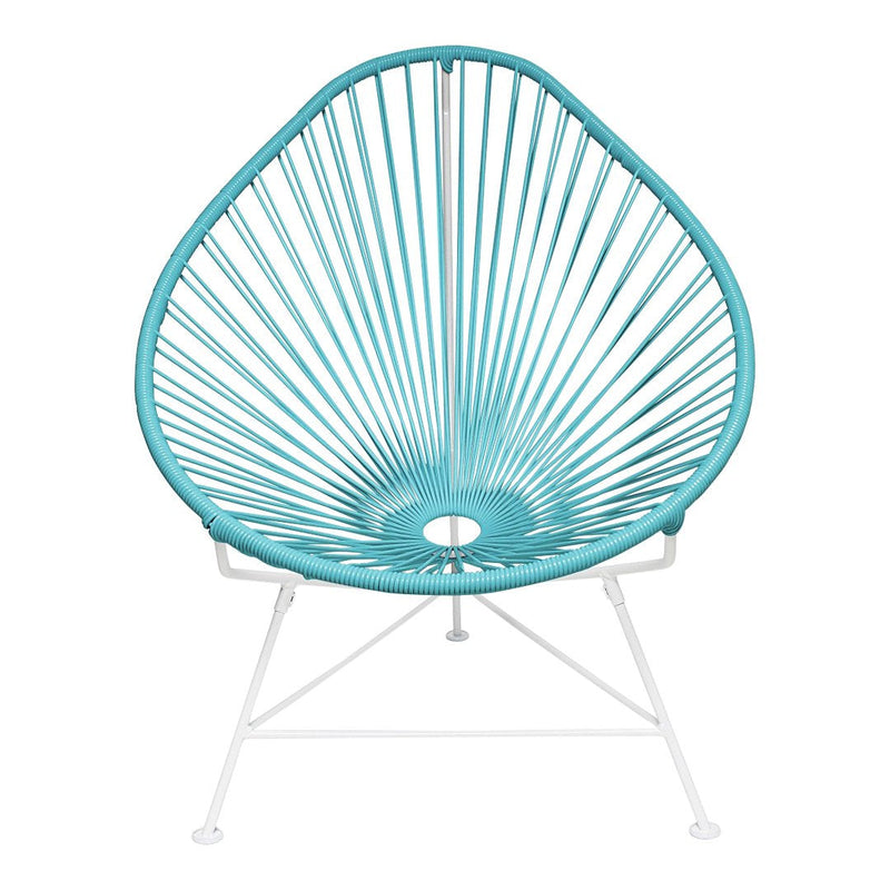 Turquoise Acapulco chair with a unique, concentric pattern and white metal legs, perfect for stylish outdoor seating.