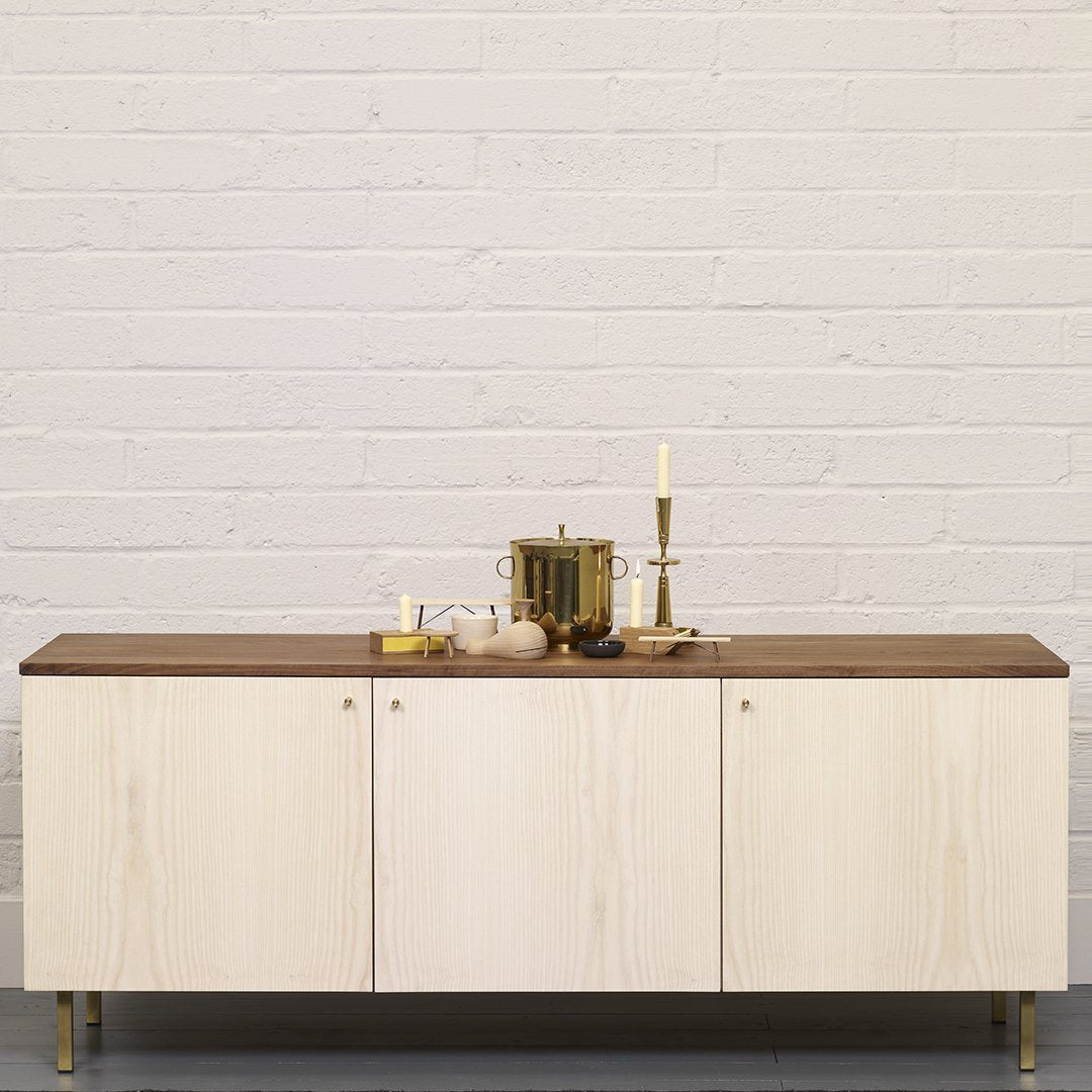 Light wood cabinet with a dark wood top, featuring sleek lines and modern design elements for a contemporary look.