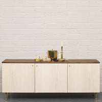 Light wood cabinet with a dark wood top, featuring sleek lines and modern design elements for a contemporary look.