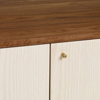 Wooden cabinet with a rich walnut top and light wood grain pattern on doors, featuring a sleek brass knob.