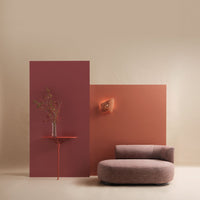 Brown and burgundy backdrop with a coral accent wall, featuring textured fabrics and a modern design elements.