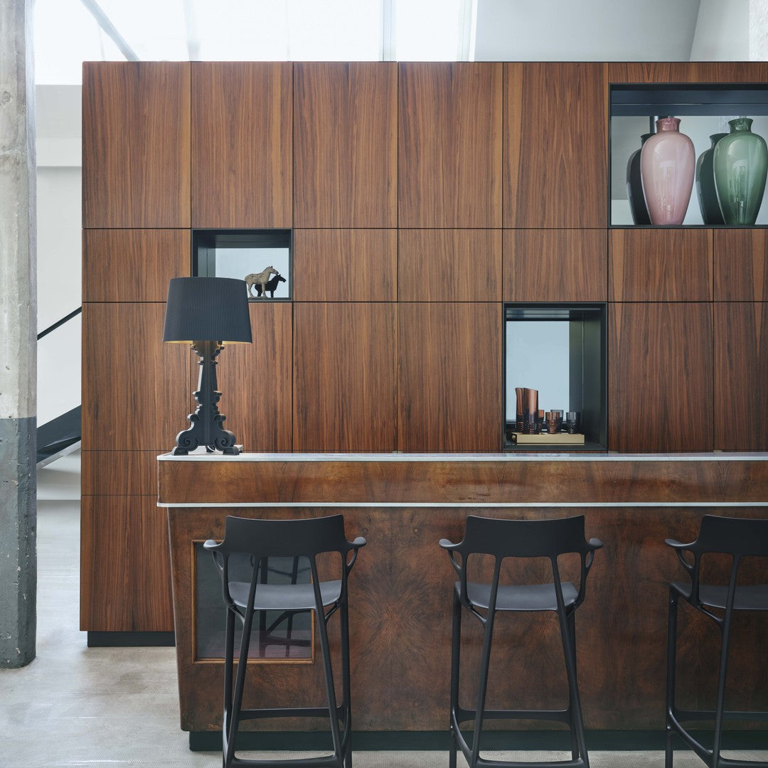 Sleek wood tones in rich brown hues with elegant black accents and colorful vases in soft pink and green.
