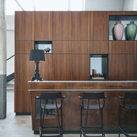 Sleek wood tones in rich brown hues with elegant black accents and colorful vases in soft pink and green.
