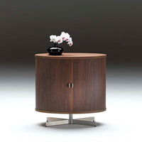 Round wooden side table in rich walnut finish with vertical grooves, accented by a chrome base and elegant vase.