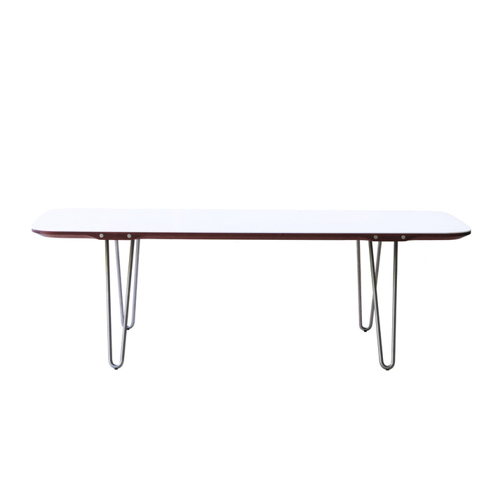 Modern white table with sleek wood trim and metal legs, featuring a minimalist design for contemporary spaces.
