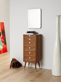 Mid-century wooden dresser in warm walnut finish with sleek white accents, complemented by a minimalist mirror.