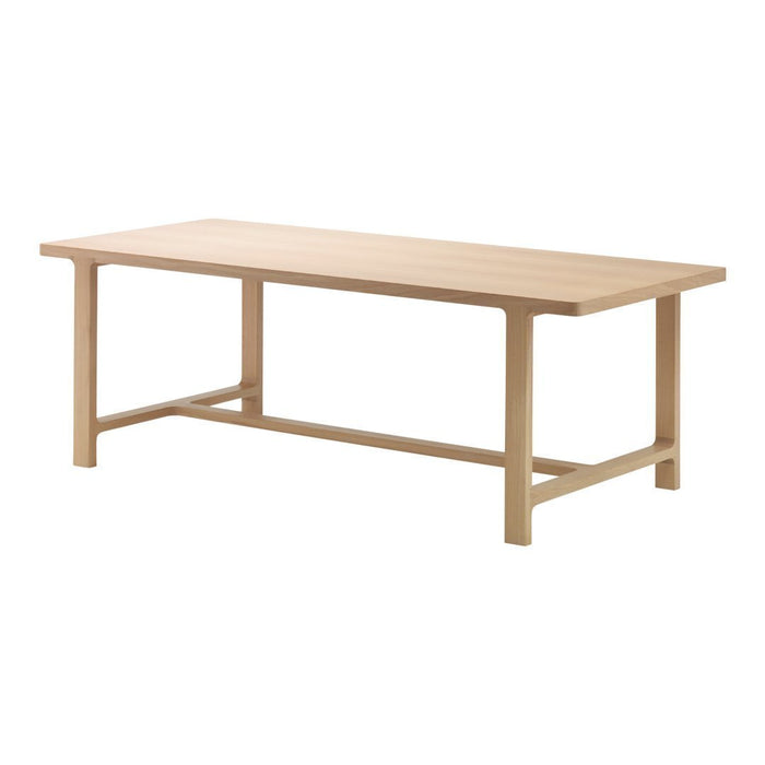 Light natural wood dining table with a simple, clean design and smooth surface, showcasing light beige tones.