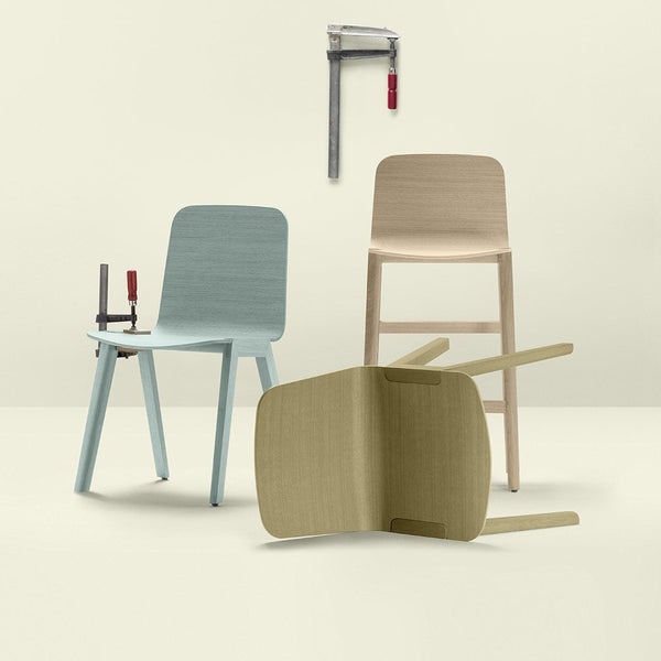 "Light blue, beige, and natural wood chairs with sleek, simple patterns against a soft neutral background."