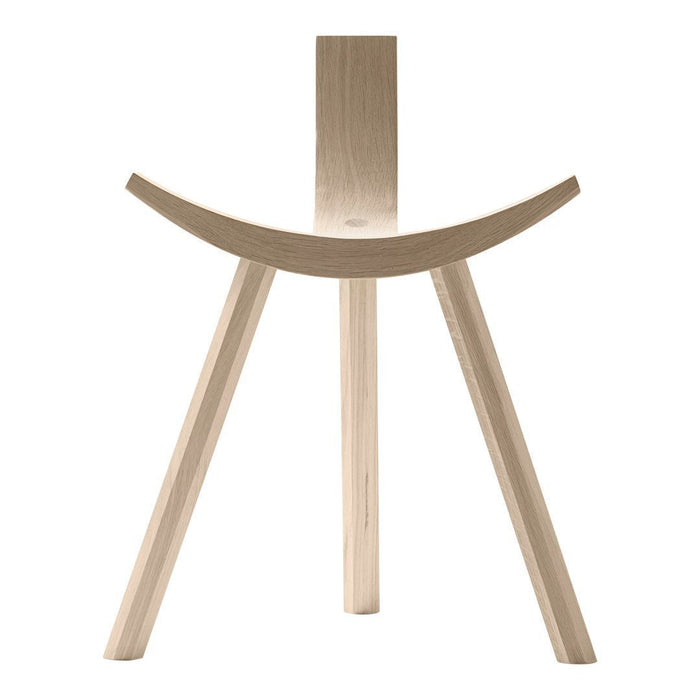 Light wood chair with minimalist design and smooth, curved seat featuring natural wood grain pattern.