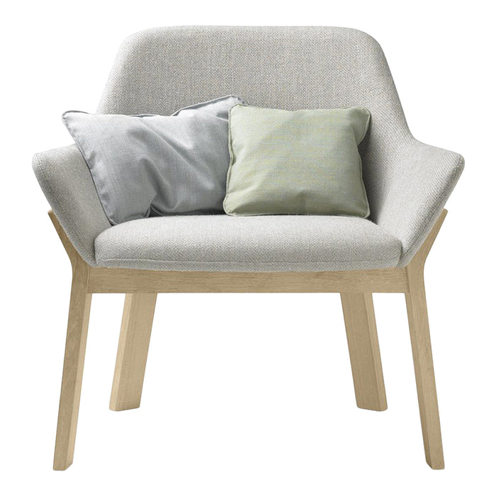 Light gray upholstered armchair with natural wood legs and decorative pillows in soft gray and pastel green tones.