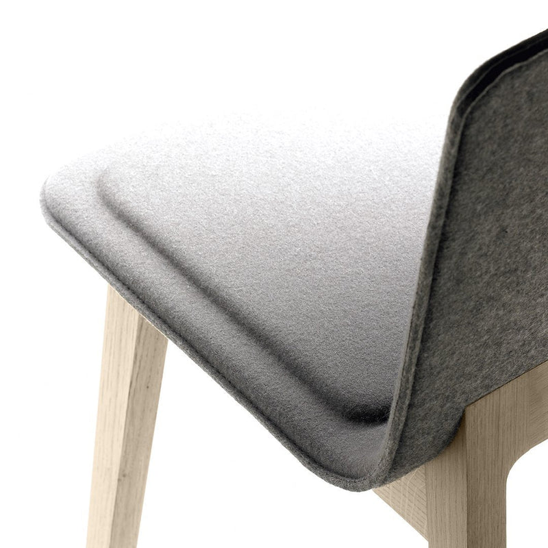 Gray textured upholstery with soft, smooth edges, paired with natural wood legs for a contemporary look.