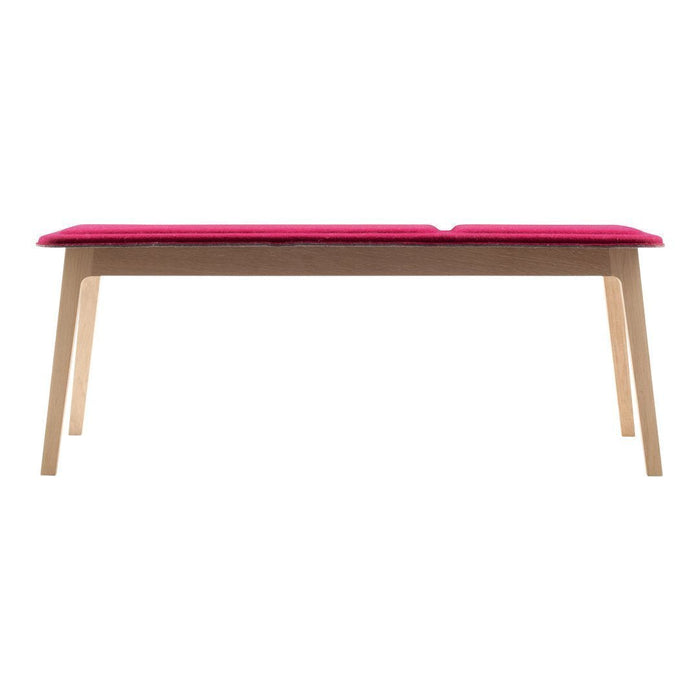 Pink cushioned tabletop on natural wood legs, creating a modern and stylish look. Perfect for any contemporary space.