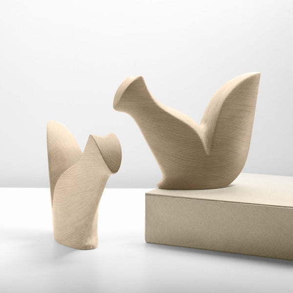 Minimalist beige ceramic sculptures with smooth contours, featuring a natural, textured finish. Perfect for modern decor.