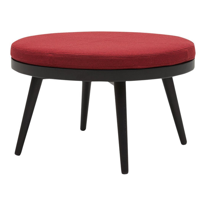 Round red cushion ottoman with sleek black wooden legs, perfect for modern decor.