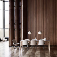 Modern dining area with warm wood textures, soft beige chairs, and patterned wood flooring for a cozy aesthetic.