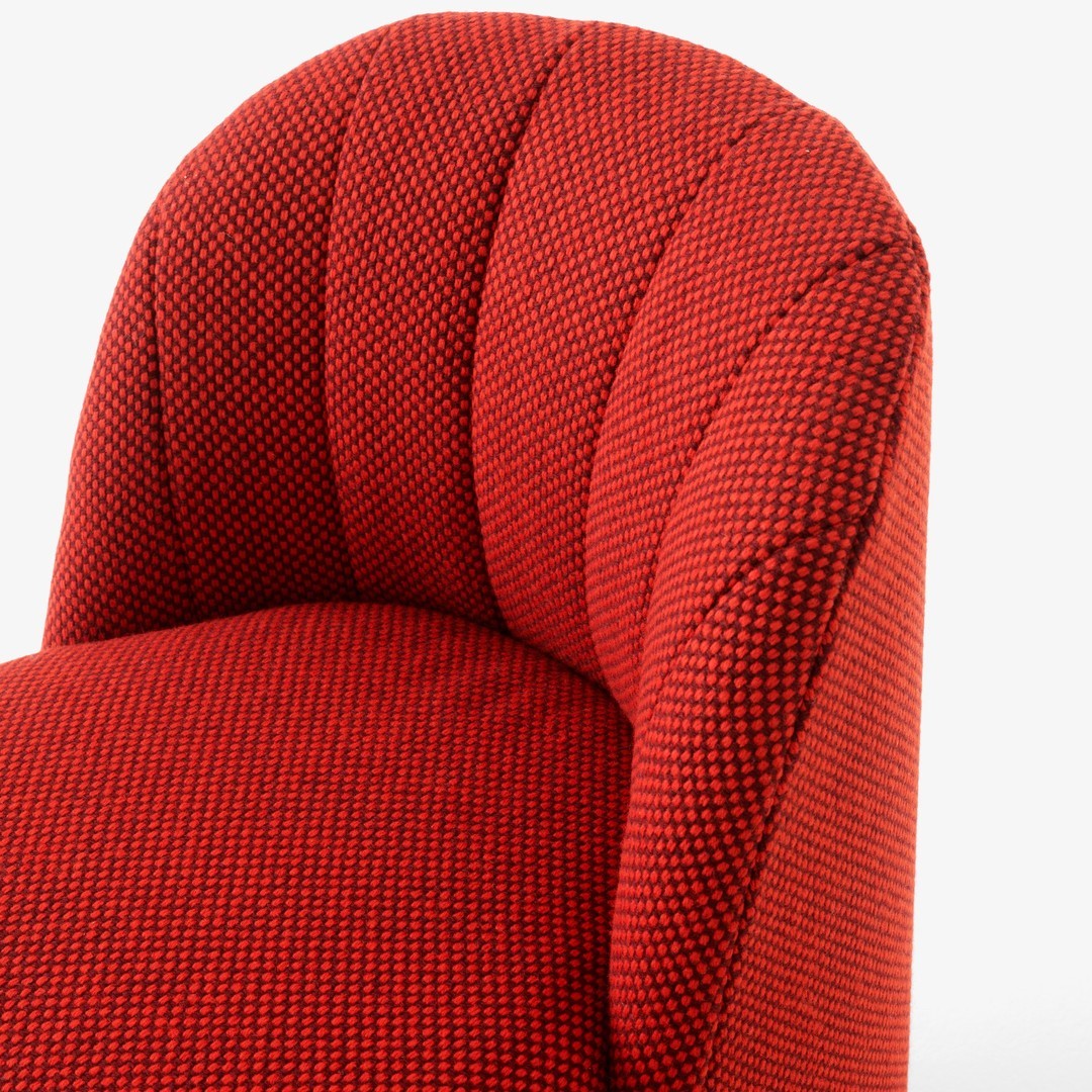 Textured red upholstery with a subtle houndstooth pattern, featuring deep, rich tones and a modern, stylish design.
