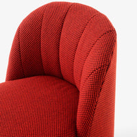 Textured red upholstery with a subtle houndstooth pattern, featuring deep, rich tones and a modern, stylish design.