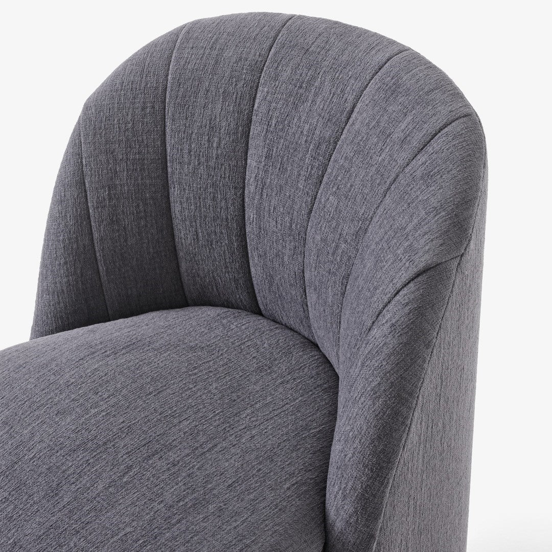Gray textured fabric armchair close-up with curved, ribbed pattern. Stylish and modern home decor accent.