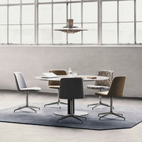 Modern dining set features gray and beige tones, with geometric patterns on the upholstered chair. Soft gray area rug completes the look.