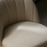 Beige textured chair upholstery with subtle horizontal stripes and a soft, cozy appearance.