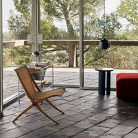 Natural wood tones, a bold red accent, and a mix of textures create a modern, inviting space.