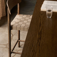 Natural wood tones with a beige woven seat pattern, enhancing a modern, minimalist aesthetic.