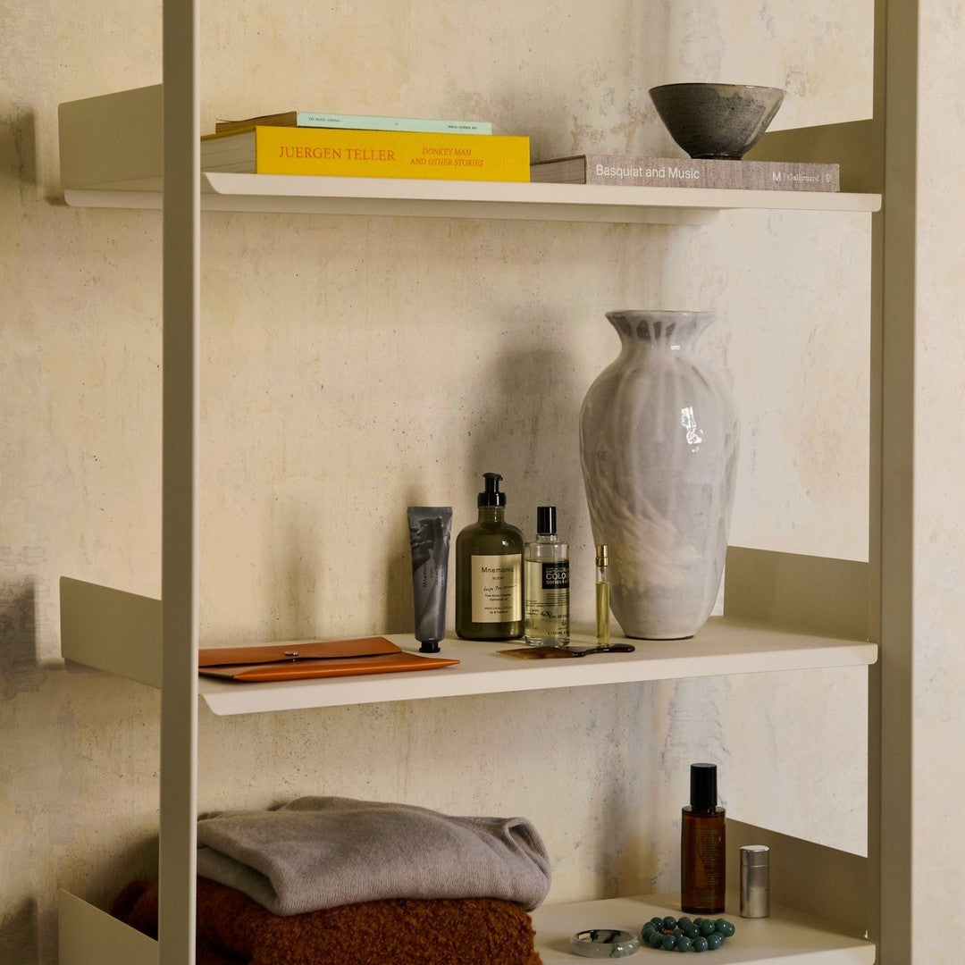 Neutral shelves with a mix of grey, orange, and green accents, featuring textured surfaces and elegant patterns.