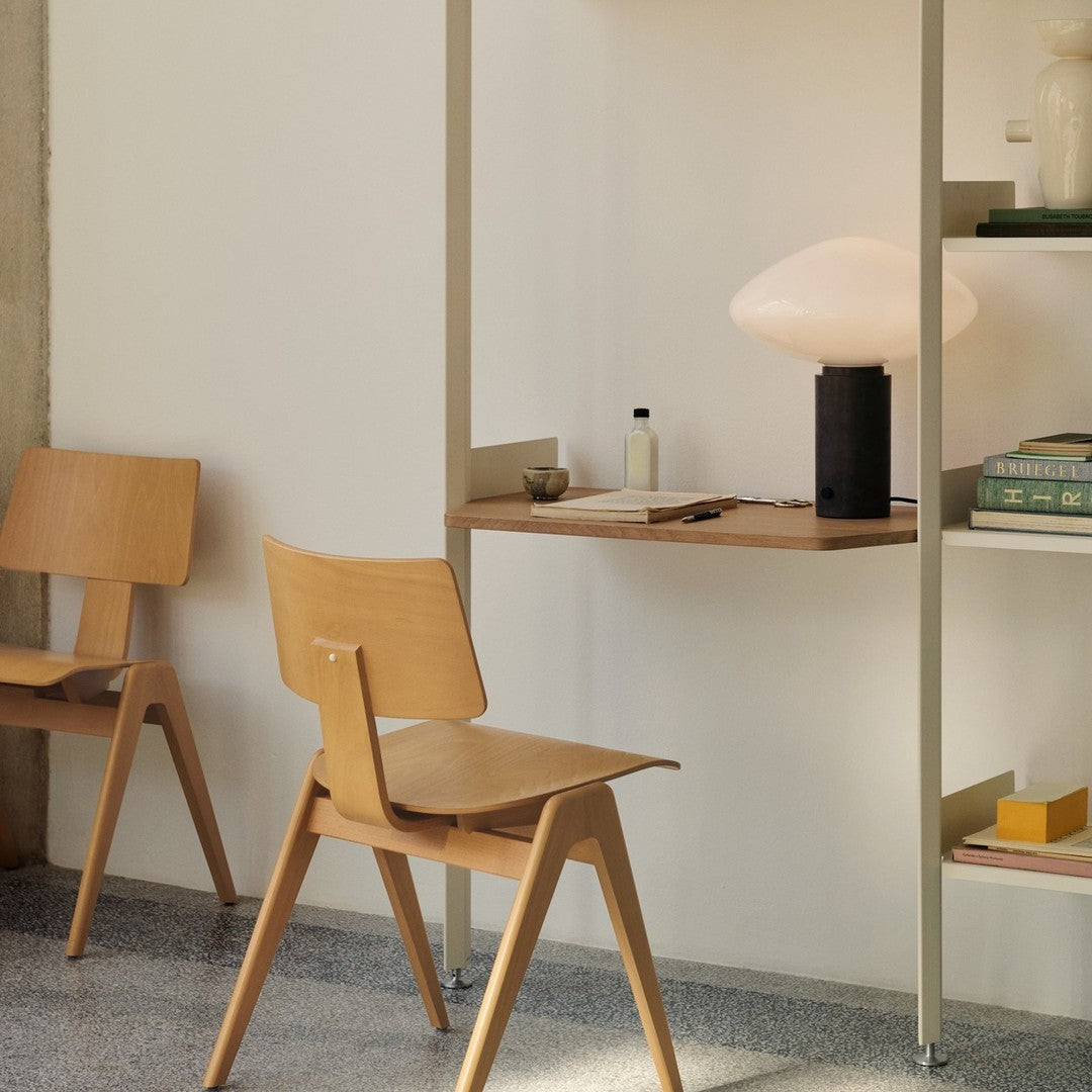 Light wood chairs and shelves with a soft beige backdrop, showcasing minimalist design and muted color palette.