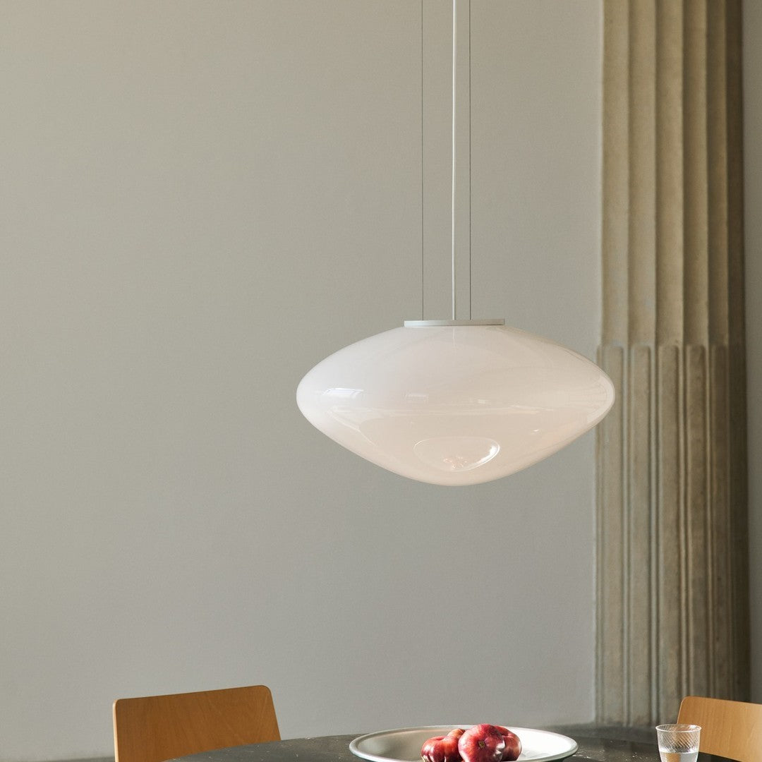 Sleek white pendant lamp with a minimalist design, illuminating the space with a soft glow. Ideal for modern interiors.