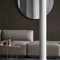 "Modern gray sofa with clean lines, featuring a soft fabric texture, set against a dark, minimalist background."