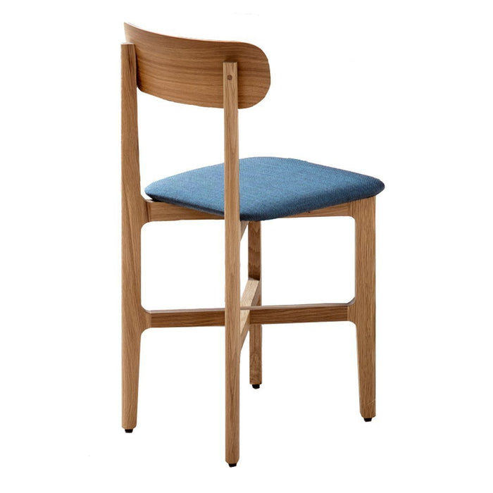 Light wood back and legs with a deep blue upholstered seat, showcasing a modern, minimalist design.