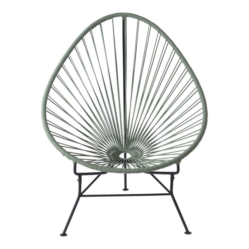Green Acapulco chair with a unique open lattice design and black metal frame, perfect for modern outdoor decor.