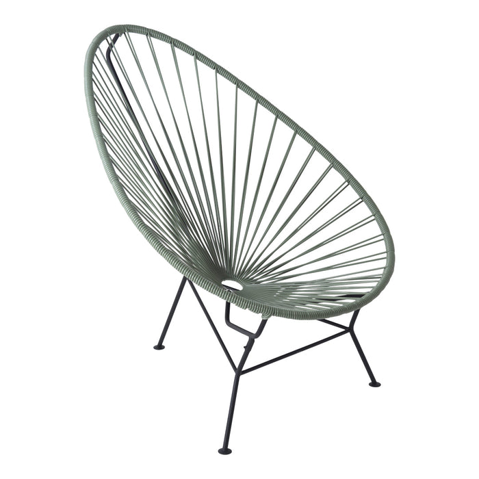 Green Acapulco chair with a round, open weave pattern and black metal legs, perfect for modern outdoor decor.