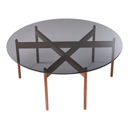 Round glass table with a smoky gray top and walnut wood base featuring an intersecting cross pattern.