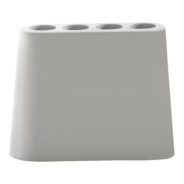 Sleek gray pen holder with a smooth finish and four cylindrical openings for writing utensils.