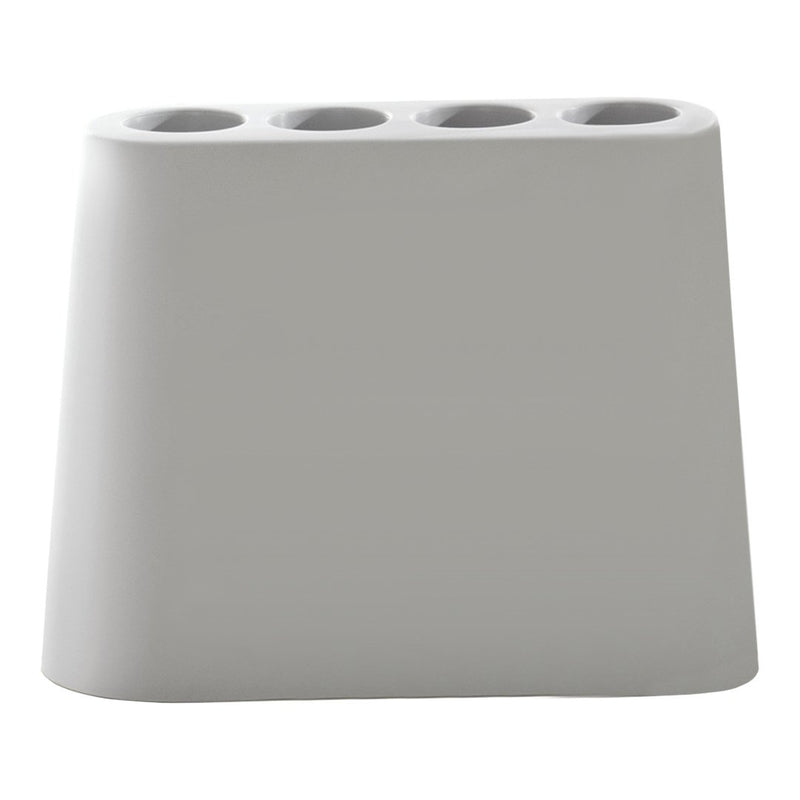 Sleek gray pen holder with a smooth finish and four cylindrical openings for writing utensils.