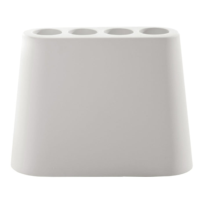 White ceramic flower pot with a minimalist design featuring four circular cutouts at the top.