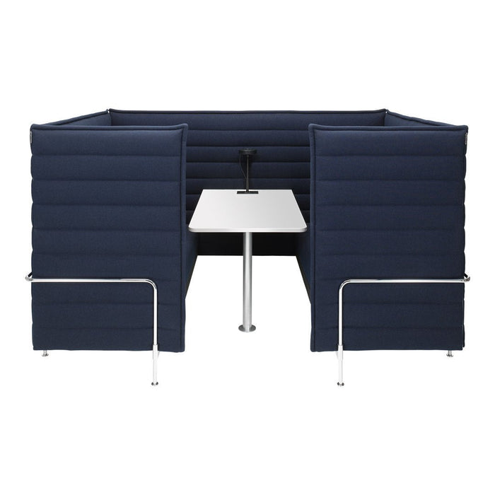 Navy blue padded booth with sleek white table and chrome legs, offering a modern, minimalist design.