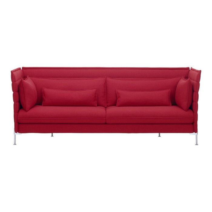 Bright red sofa with modern, textured upholstery and matching throw pillows, featuring sleek metallic legs.
