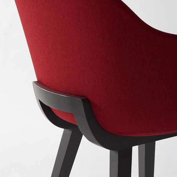 Red upholstered chair with a sleek black base, featuring a textured fabric pattern. Modern and stylish design element.
