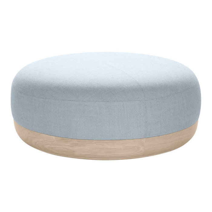 Light blue round pouf with a smooth fabric surface and a natural wood base. Minimalist design, calming colors.