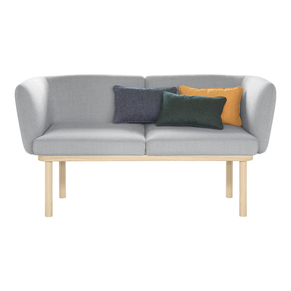 Light gray fabric sofa with a minimalist design, featuring colorful accent pillows in teal, mustard, and navy.